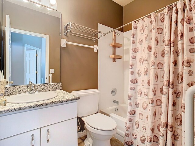 bathroom with toilet, shower / tub combo, and vanity