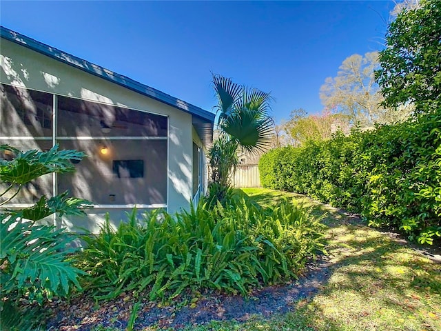 view of property exterior with fence and stucco siding