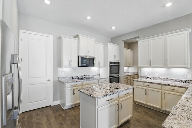 kitchen featuring dark wood finished floors, decorative backsplash, and appliances with stainless steel finishes