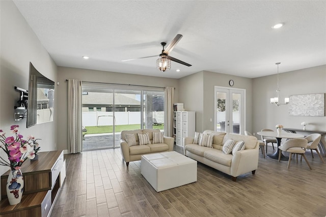 living room featuring a wealth of natural light, french doors, and dark wood-style floors