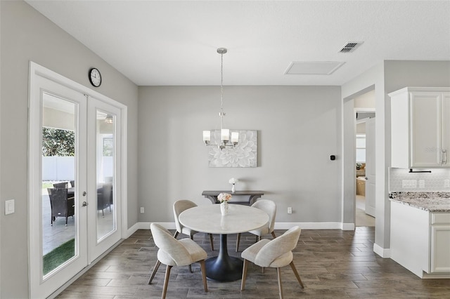 dining room with visible vents, dark wood-type flooring, baseboards, french doors, and a notable chandelier