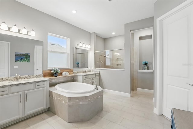 full bathroom with a sink, a garden tub, tile patterned flooring, and a walk in shower