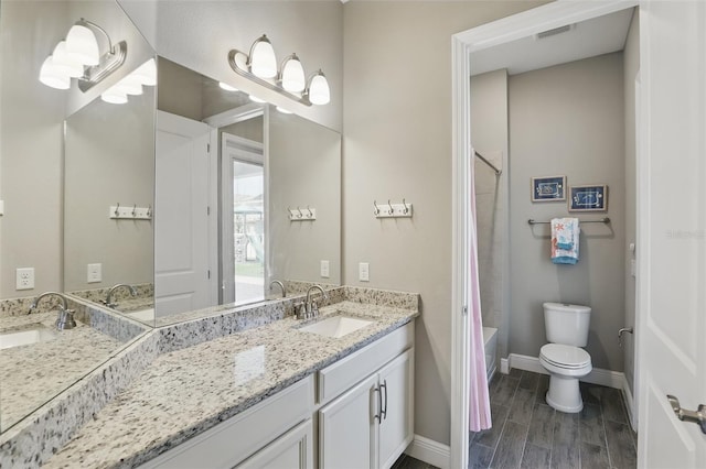 bathroom featuring vanity, toilet, visible vents, and wood tiled floor