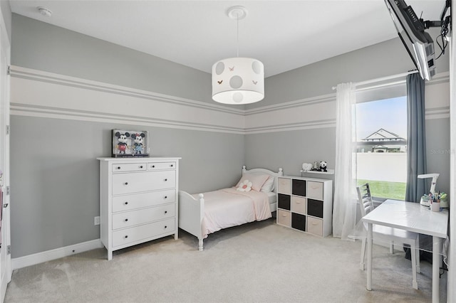 bedroom with light colored carpet and baseboards