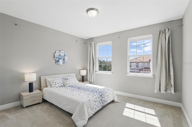 bedroom featuring carpet flooring and baseboards