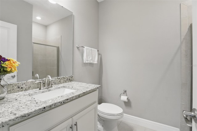 full bath with tile patterned floors, toilet, a stall shower, baseboards, and vanity