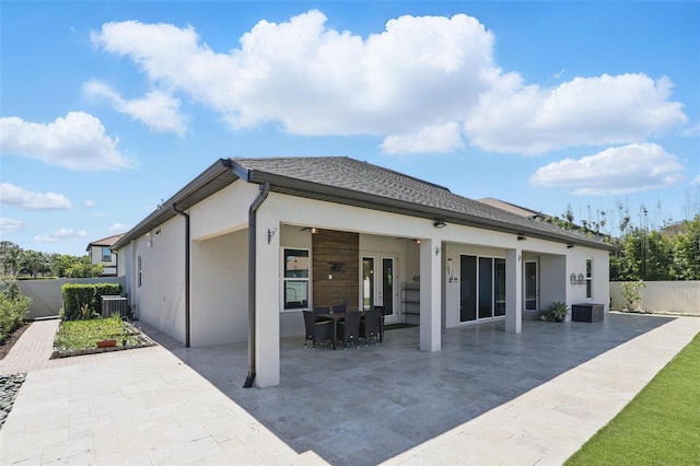 back of house featuring stucco siding, a patio, fence private yard, and central air condition unit