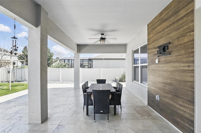 view of patio / terrace with outdoor dining area, a fenced backyard, and ceiling fan