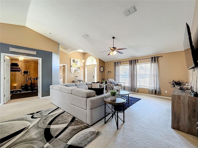 living area featuring lofted ceiling, visible vents, ceiling fan, and light carpet