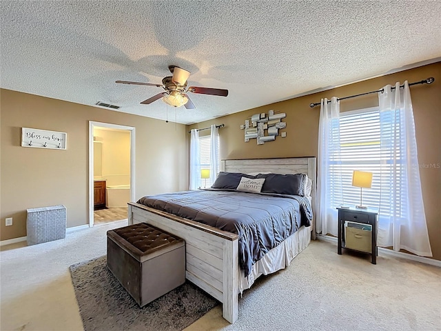 bedroom with multiple windows, visible vents, and light colored carpet