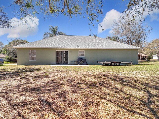 back of property featuring stucco siding