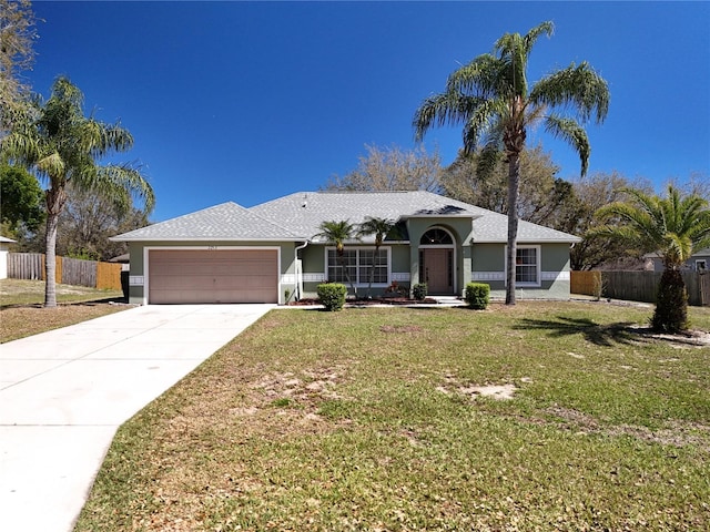 single story home featuring an attached garage, fence, and a front yard