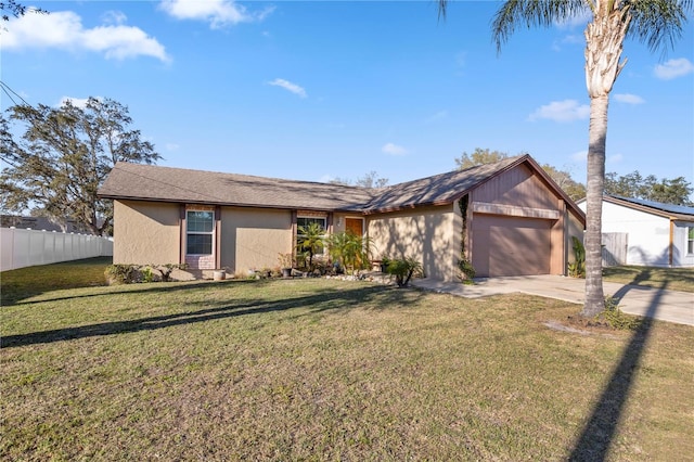 mid-century modern home with stucco siding, a front lawn, fence, concrete driveway, and a garage