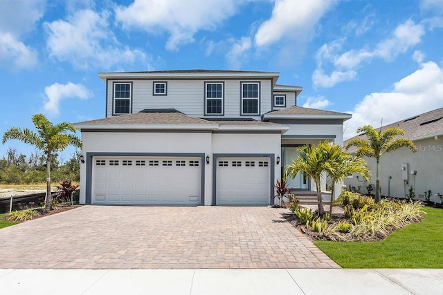 1067 Signet, Apollo Beach, FL 33572 - view of front of house with decorative driveway, a shingled roof, and stucco siding