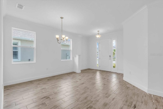 1067 Signet, Apollo Beach, FL 33572 - entryway featuring a chandelier, light wood-style floors, and baseboards