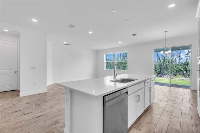 1067 Signet, Apollo Beach, FL 33572 - kitchen featuring a sink, dishwasher, light countertops, light wood-style floors, and white cabinets