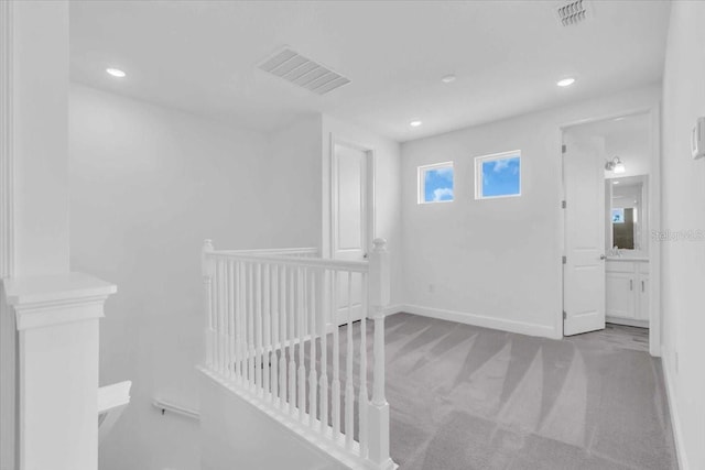 1067 Signet, Apollo Beach, FL 33572 - hall featuring carpet flooring, an upstairs landing, baseboards, and recessed lighting