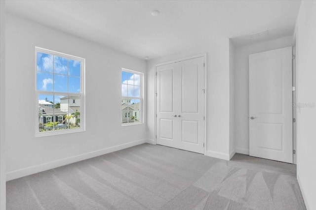 1067 Signet, Apollo Beach, FL 33572 - unfurnished bedroom with baseboards, carpet flooring, and a closet