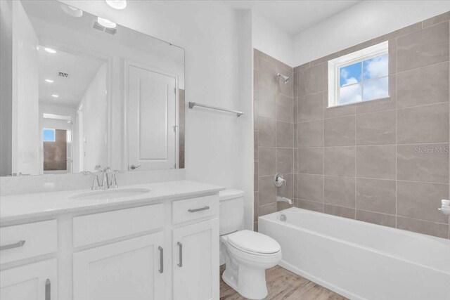 1067 Signet, Apollo Beach, FL 33572 - full bathroom with toilet, bathtub / shower combination, vanity, and wood finished floors