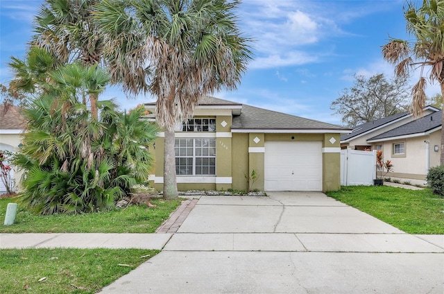 view of front of property featuring a shingled roof, concrete driveway, an attached garage, fence, and stucco siding