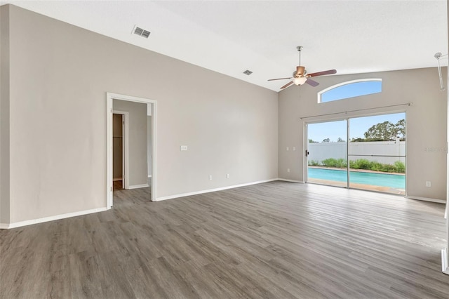 spare room with a ceiling fan, baseboards, and wood finished floors