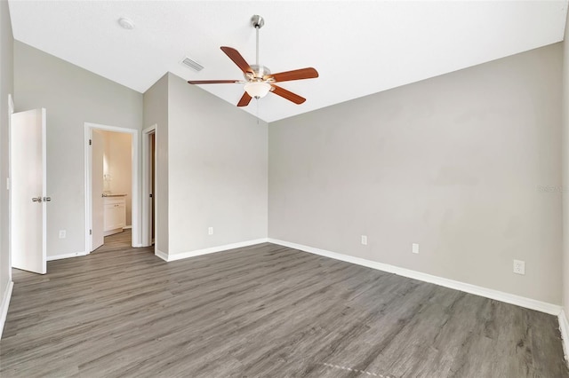 empty room with lofted ceiling, wood finished floors, visible vents, and a ceiling fan