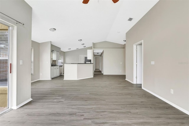 unfurnished living room with ceiling fan, lofted ceiling, visible vents, baseboards, and light wood-type flooring