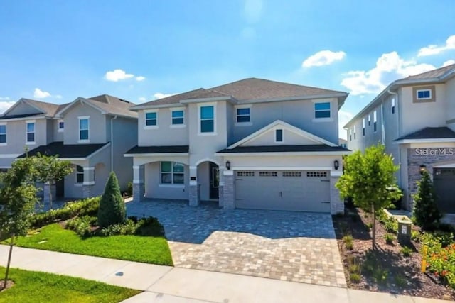 view of front of home featuring decorative driveway and an attached garage