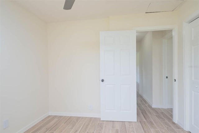 unfurnished room with wood finish floors and baseboards