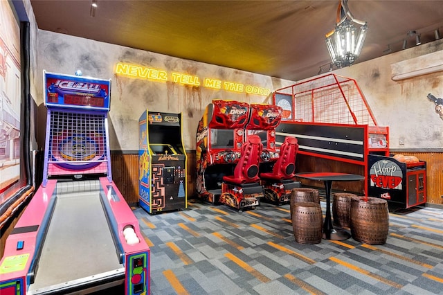 recreation room with a wainscoted wall and carpet floors