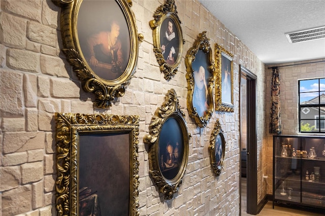 room details with visible vents and a textured ceiling