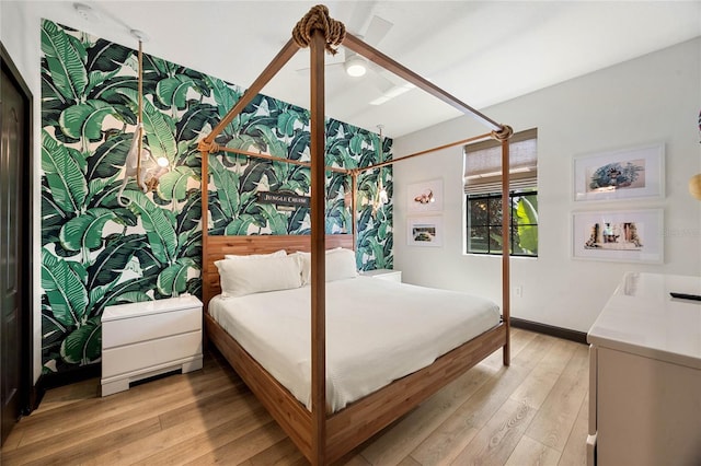 bedroom with light wood-style flooring and baseboards