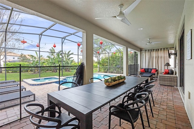 view of patio / terrace with a pool with connected hot tub, a lanai, ceiling fan, and outdoor dining area