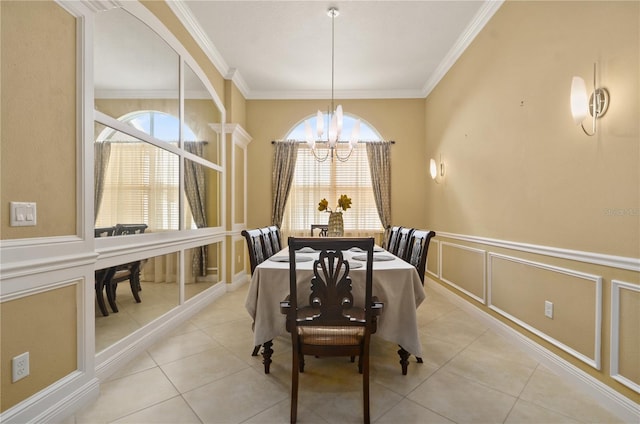 dining room with plenty of natural light, crown molding, a decorative wall, and an inviting chandelier