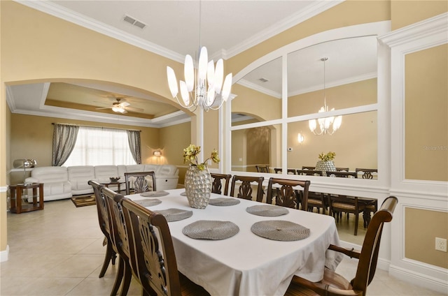 dining room featuring visible vents, ornamental molding, ceiling fan with notable chandelier, arched walkways, and light tile patterned floors