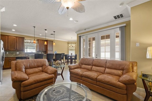 living area featuring light tile patterned flooring, french doors, visible vents, and ornamental molding