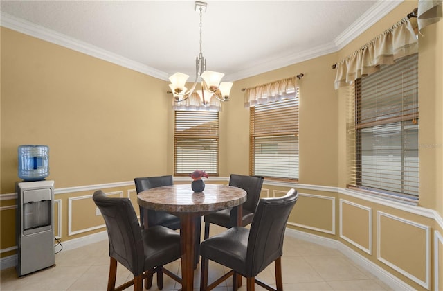 dining area featuring a wainscoted wall, a notable chandelier, light tile patterned flooring, and a decorative wall