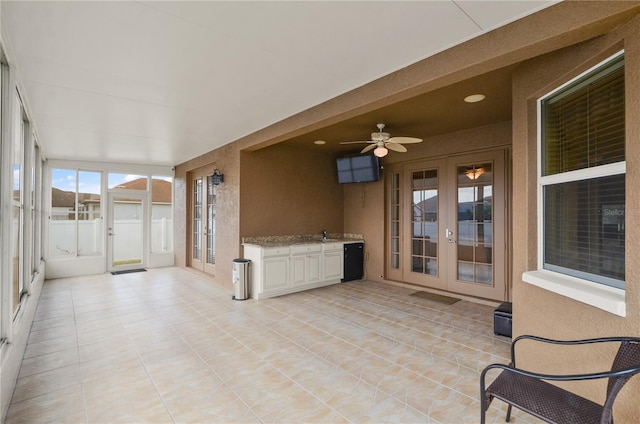 unfurnished sunroom with french doors