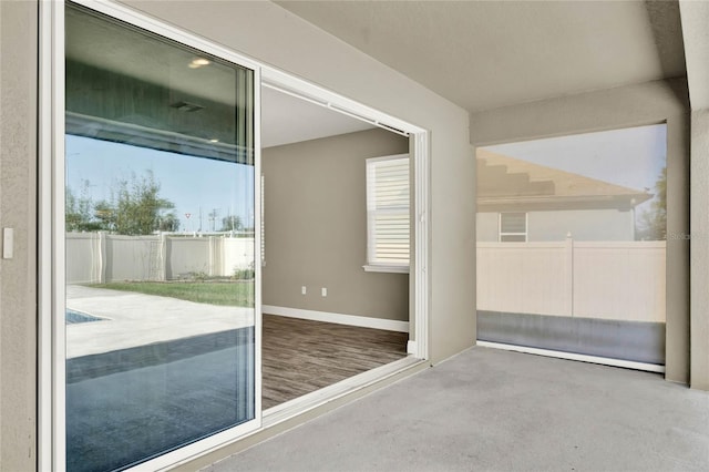 exterior space featuring carpet and baseboards