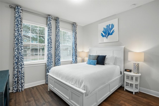 bedroom with dark wood-style flooring and baseboards