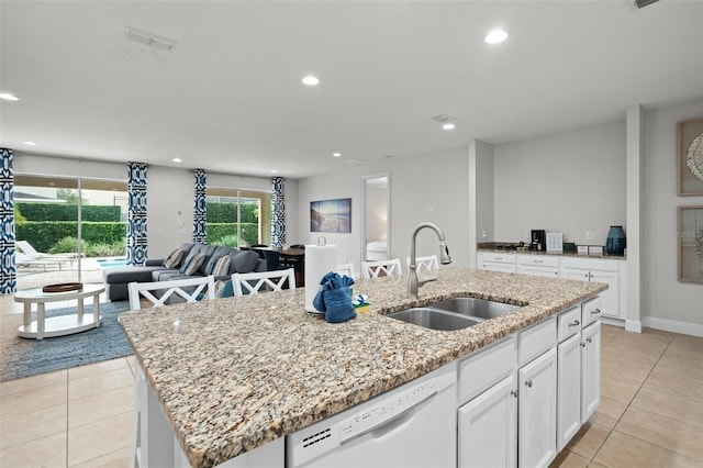 kitchen featuring light tile patterned floors, white dishwasher, recessed lighting, a sink, and a center island with sink
