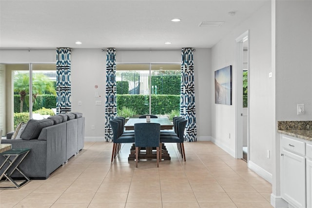 dining area featuring light tile patterned floors, plenty of natural light, baseboards, and recessed lighting