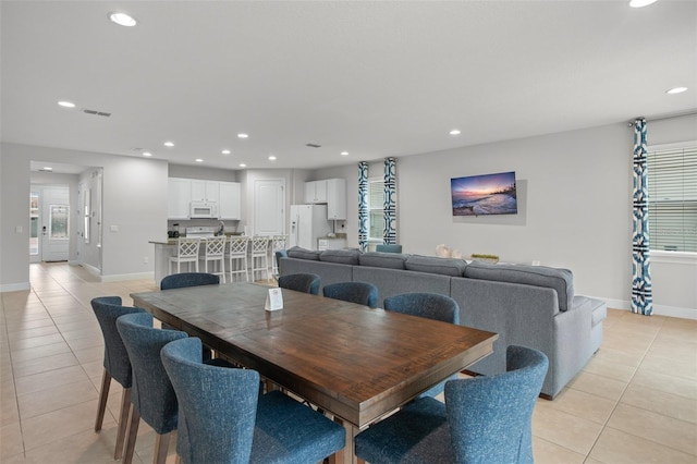 dining area with light tile patterned floors, visible vents, and recessed lighting