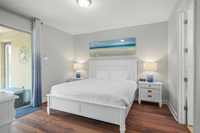 bedroom featuring baseboards and wood finished floors