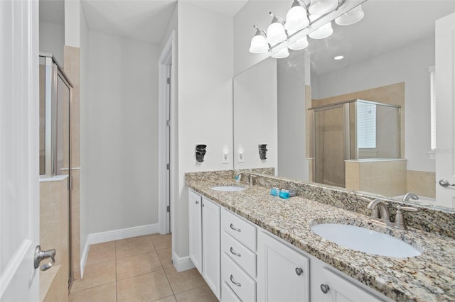 full bath featuring a stall shower, an inviting chandelier, a sink, and tile patterned floors