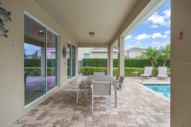view of patio featuring a fenced in pool and outdoor dining space