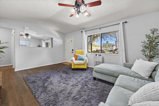 living room featuring wood finished floors, a ceiling fan, baseboards, lofted ceiling, and a textured ceiling