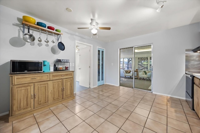 kitchen featuring light tile patterned floors, stainless steel microwave, electric stove, and ceiling fan