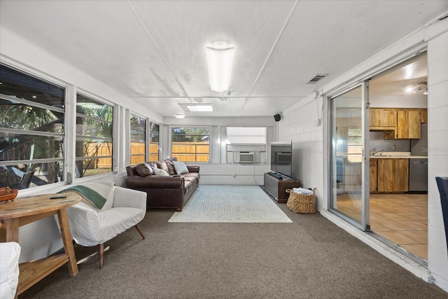 sunroom / solarium with cooling unit, visible vents, and a sink