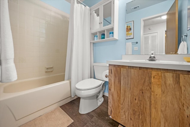 bathroom featuring visible vents, toilet, wood finished floors, vanity, and shower / bathtub combination with curtain